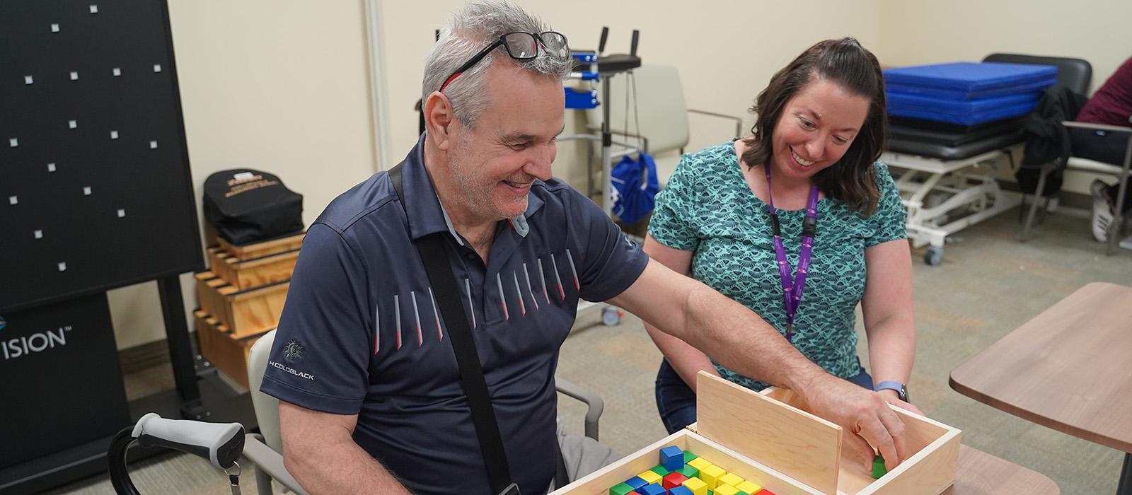 A stroke patient sorting blocks as a stroke recovery exercise