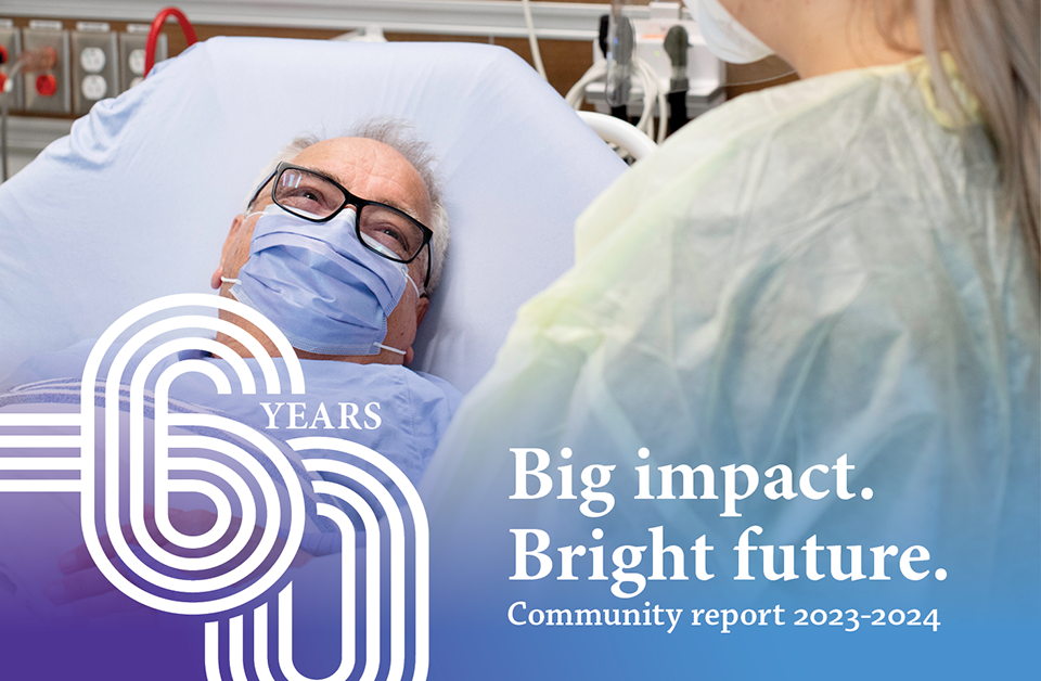 A patient with a mask on smiling up at a caretaker. The 60 years graphic with the text "Big impact. Bright future. Community report 2023-2024"