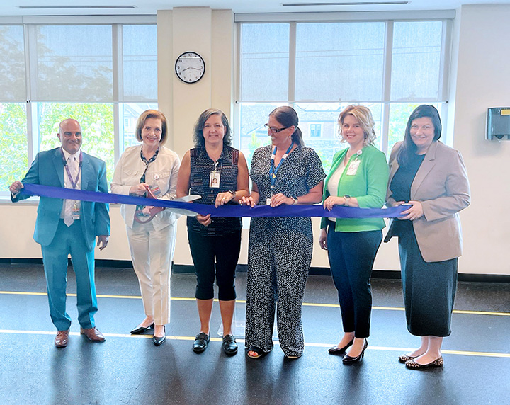 The Mackenzie Health Outpatient Stroke Clinic team along with Altaf Stationwala, CEO and President, and Mary-Agnes Wilson, EVP, COO and Chief Nursing Executive standing together for the ribbon-cutting ceremony.